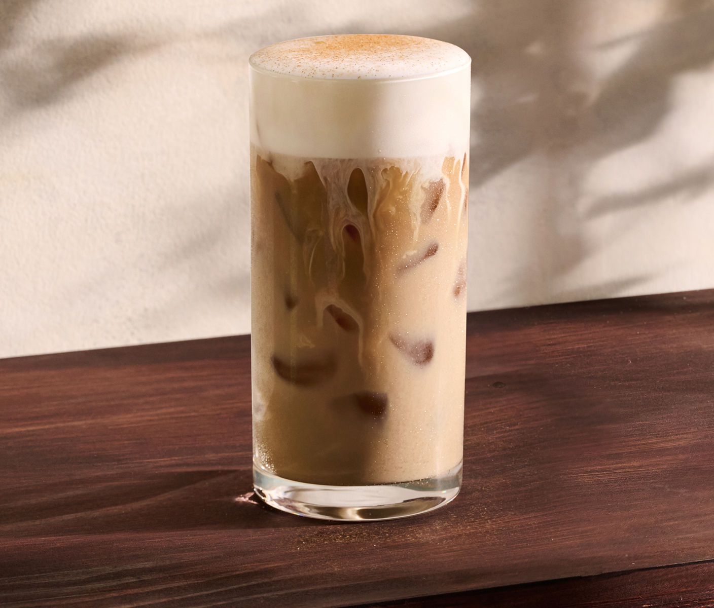 A milky iced coffee drink with brown sugar cream cold foam and spices.